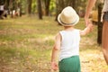 Little boy walking with mom in park.