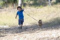 Four-year-old boy walking and having fun with his little dog in the park in the middle of nature Royalty Free Stock Photo