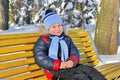Little boy walking in snow-covered park in winter Royalty Free Stock Photo