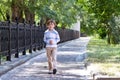 Little boy walking on a sunny street