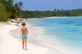 Little boy walking on tropical beach