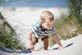 Little boy walking up the sand dune