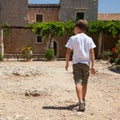 Little boy walkking to the monastery Royalty Free Stock Photo