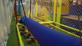 Little boy walks inside the obstacle course in the sports club