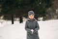 A little boy walks in the park in the winter weather, play snowballs and rejoiced. Waiting for Christmas mood Royalty Free Stock Photo