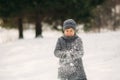 A little boy walks in the park in the winter weather, play snowballs and rejoiced. Waiting for Christmas mood Royalty Free Stock Photo