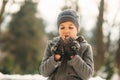 A little boy walks in the park in the winter weather, play snowballs and rejoiced. Waiting for Christmas mood Royalty Free Stock Photo