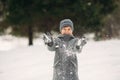 A little boy walks in the park in the winter weather, play snowballs and rejoiced. Waiting for Christmas mood Royalty Free Stock Photo