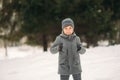 A little boy walks in the park in the winter weather, play snowballs and rejoiced. Waiting for Christmas mood Royalty Free Stock Photo