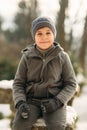 A little boy walks in the park in the winter weather, play snowballs and rejoiced. Waiting for Christmas mood Royalty Free Stock Photo