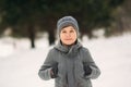 A little boy walks in the park in the winter weather, play snowballs and rejoiced. Waiting for Christmas mood Royalty Free Stock Photo