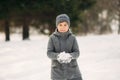 A little boy walks in the park in the winter weather, play snowballs and rejoiced. Waiting for Christmas mood Royalty Free Stock Photo