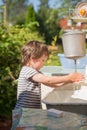 Little boy washes his hands under washstand Royalty Free Stock Photo