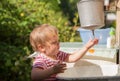 Little boy washes his hands under water dispenser Royalty Free Stock Photo