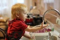 Little boy washing dishes at home Royalty Free Stock Photo