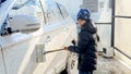 Little boy washing family car with brush and foam outside at carwash. Concept of parenting, children helping parents and Royalty Free Stock Photo