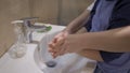 Little boy washing hands with mom. Woman teaches her son to properly wash and soap his hands. Family education concept Royalty Free Stock Photo