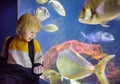 Little boy watches fishes in seaquarium Royalty Free Stock Photo