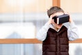 Little boy watching movie in VR virtual reality goggles Royalty Free Stock Photo