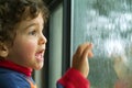 Little boy watching the rain Royalty Free Stock Photo