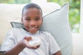 Little boy watching tv on the couch Royalty Free Stock Photo