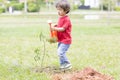 Little boy watering plants Outdoors