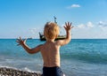 Little boy waving to an old sailing ship Royalty Free Stock Photo