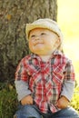 Little boy wearing a cowboy hat playing on nature Royalty Free Stock Photo