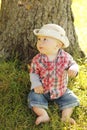 Little boy wearing a cowboy hat playing on nature Royalty Free Stock Photo