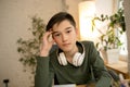 Little boy wearing headphones during online education course, lesson, view of screen