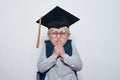Little boy wearing in student hat. White background. Sly schoolboy plotted prank. Half-length portrait Royalty Free Stock Photo