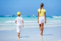 Boy with his sister walking on tropical ocean beach. Kid during family sea vacation. Royalty Free Stock Photo