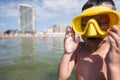 Little boy wearing yellow diving mask and swimming goggles on the beach Royalty Free Stock Photo