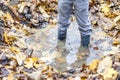 Little boy with wellys in the puddle