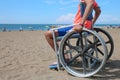 Little boy on the wheelchair on the beach at resort