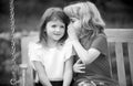 Little boy whispers to lovely girl in ear. Brother and sister playing in spring park outdoors. Little boy and girl kids Royalty Free Stock Photo