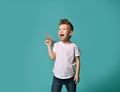 Little boy ready to launch a paper plane looks up to sky and shouts. overcome. Royalty Free Stock Photo