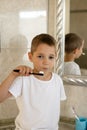 Little boy in white t-shirt brushing his teeth.Milk teeth are replaced by molars Royalty Free Stock Photo