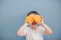 Little boy in white t-shirt holds two orange slices Royalty Free Stock Photo