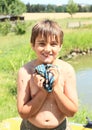 Little boy wringing wet t-shirt