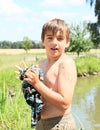 Little boy wringing wet t-shirt