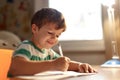 Little boy write into exercise book