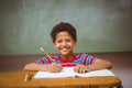 Little boy writing book in classroom Royalty Free Stock Photo