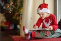 Little boy writing the letter to Santa. Child dreams of a gift that he can receive