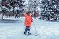 Little boy 3-4 years old, winter children`s skis, happy smiling plays, having fun, active image of children. Background