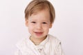 A little boy of 2 years in a sleeping bag on the bed. A handsome boy in pajamas is sitting on the bed and smiling Royalty Free Stock Photo