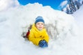 Little boy in yellow inside snow cave Royalty Free Stock Photo