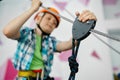 Little boy on zip line, young climber in helmet