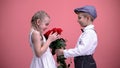 Little boyfriend giving bouquet of roses to young female, Valentines day, love