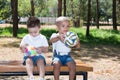 Little boys: African American and caucasian with soccer ball in park on nature at summer Royalty Free Stock Photo